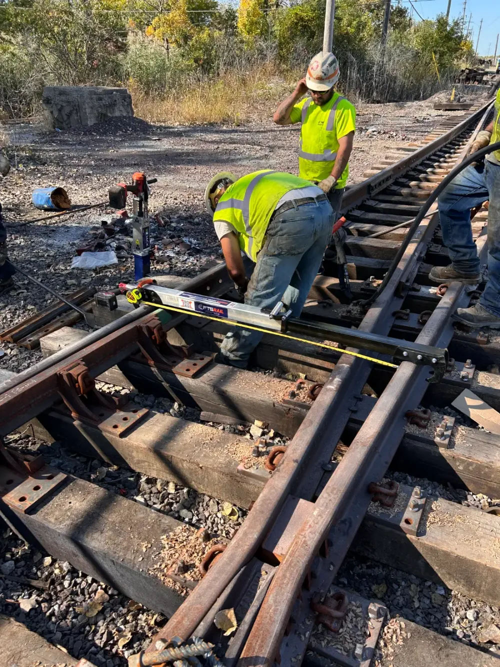 Railroad track crew checking gauge on a turnout with the FTS Rail Quick Gauge