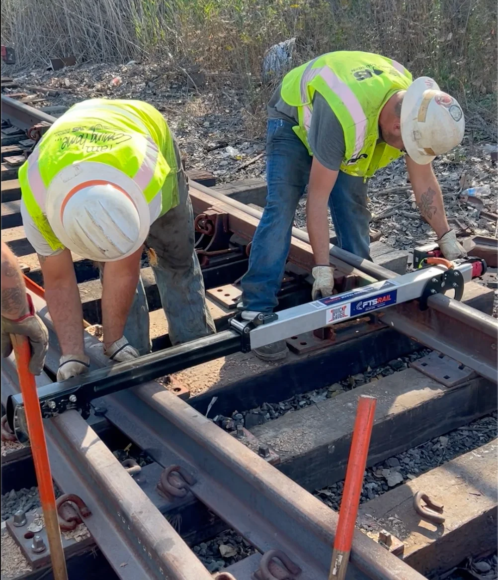 Norfolk Southern railroad crew gauging a switch with the FTS Rail Quick Gauge