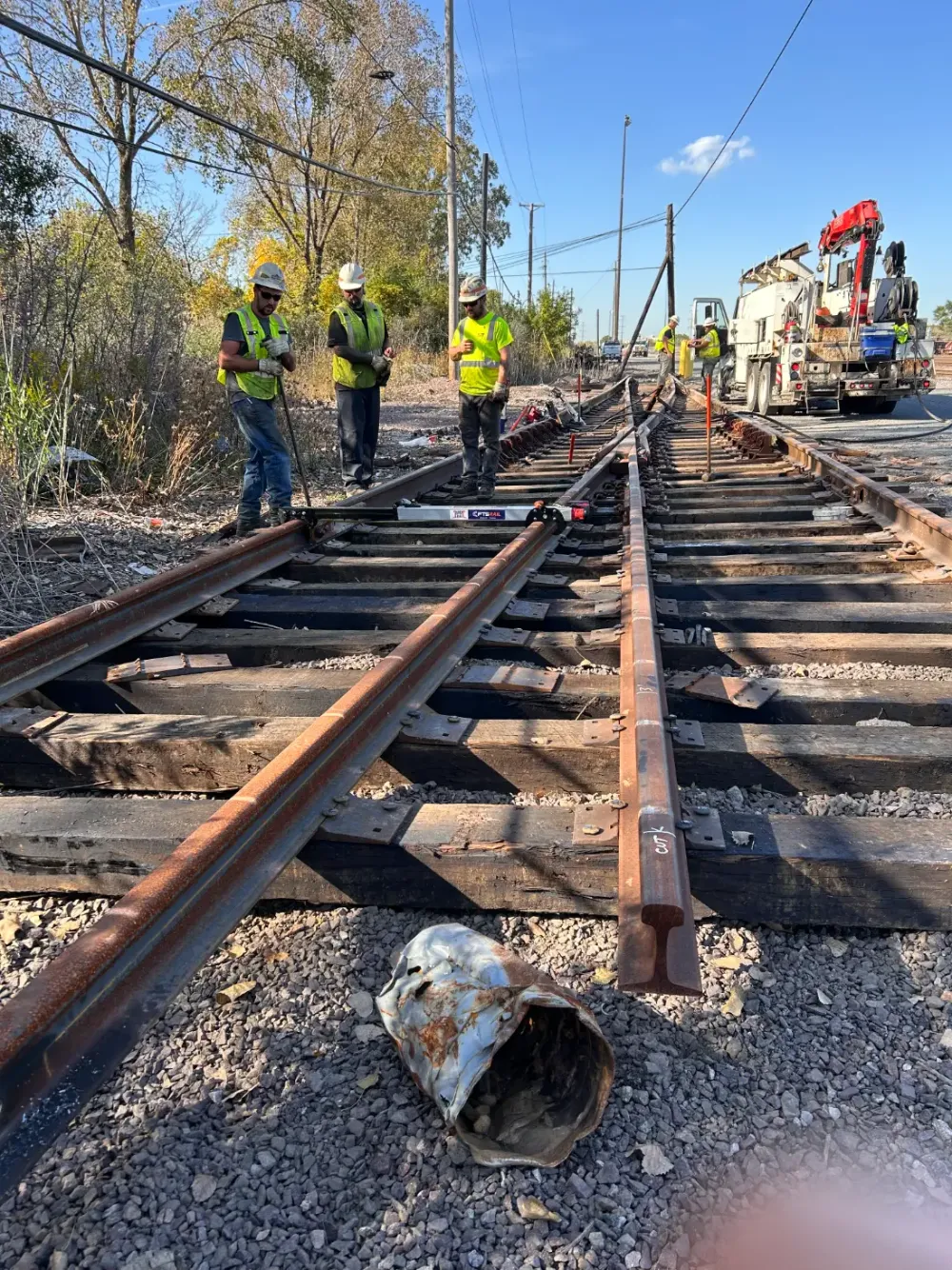 Railroad crew using the FTS Rail Quick Gauge on switch track
