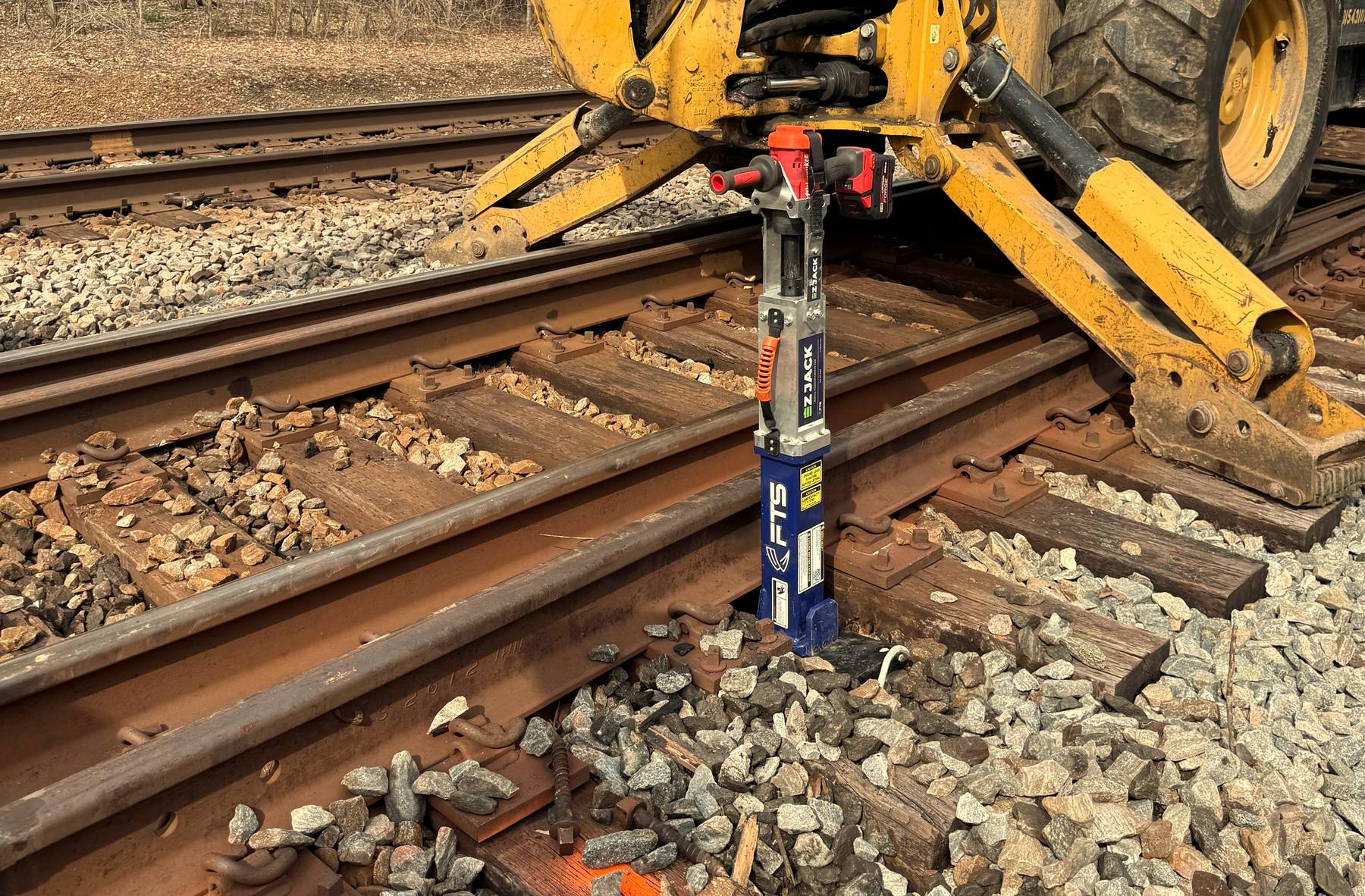 EZ-Jack battery-powered railroad jack being used during track maintenance