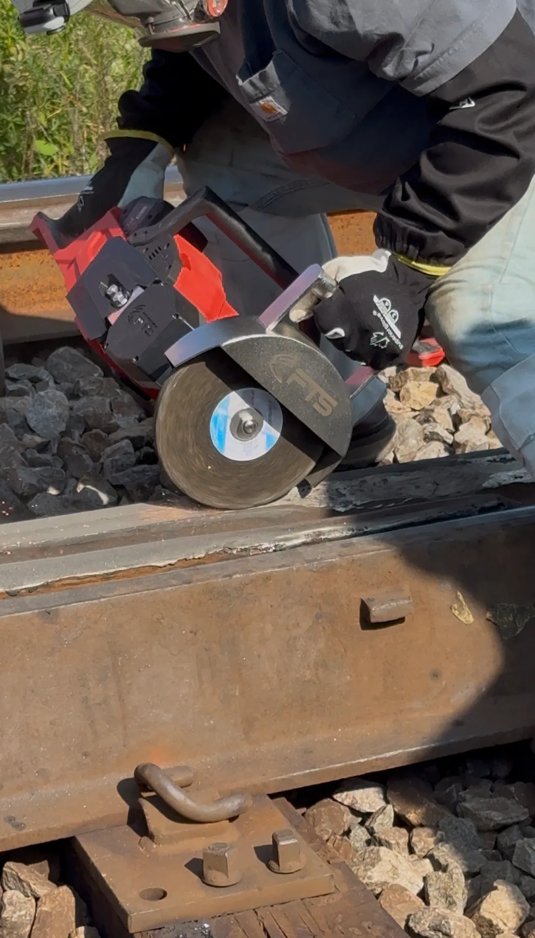 Railroad worker using the FTS Rail Frog Grinder on a rail frog