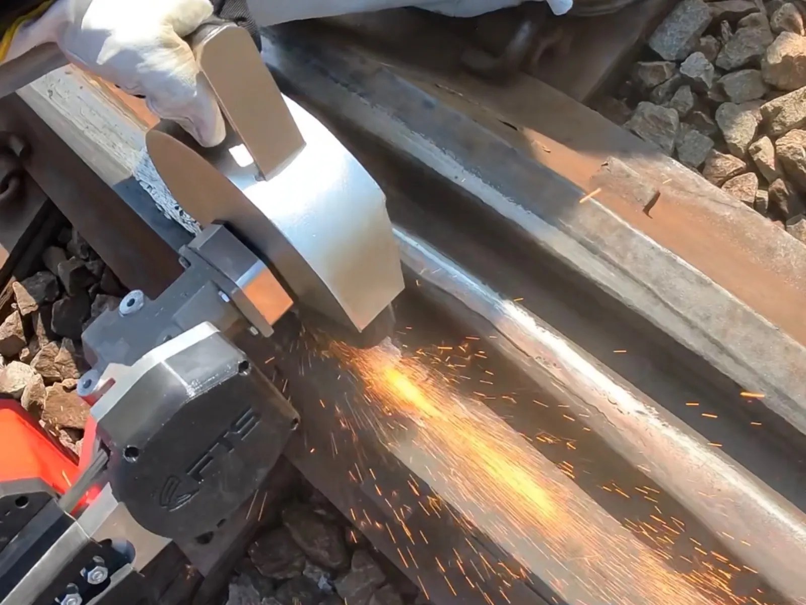 Overhead view of the Frog Grinder producing sparks while grinding a railroad frog