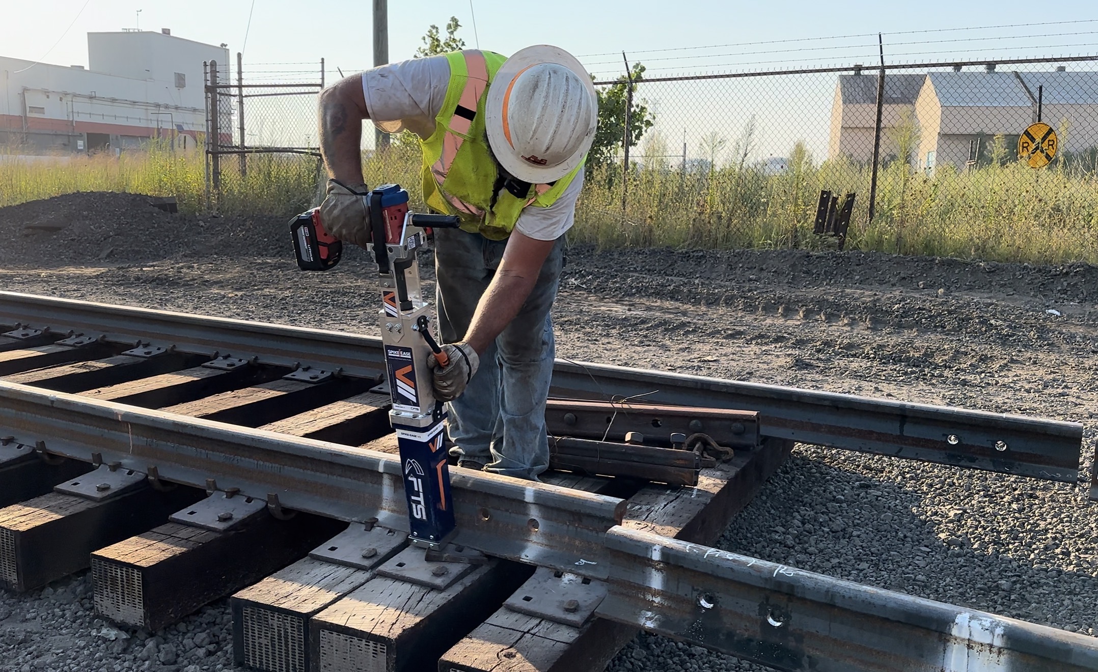 Railroad crew using the FTS Rail SpikeEase battery-powered spike puller during track maintenance