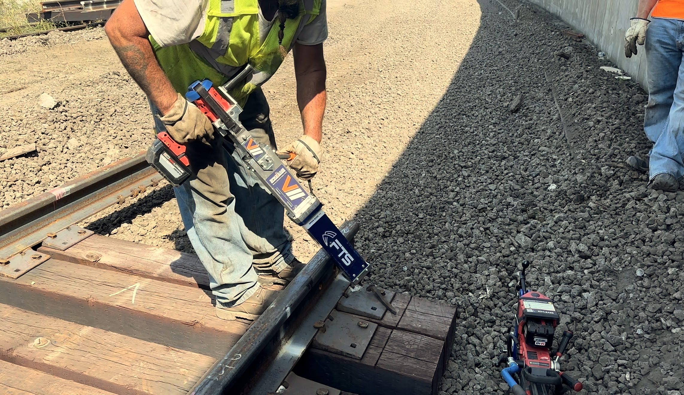 SpikeEase battery-powered spike puller being used during railroad track maintenance